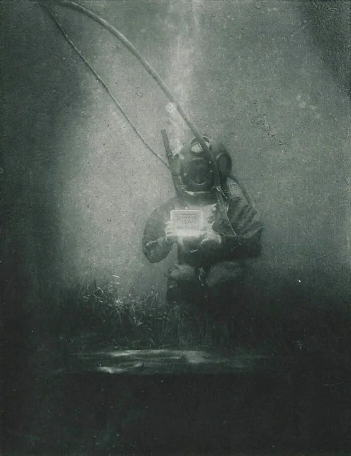 Vintage deep water diver wearing old diving suit underwater