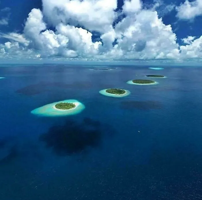 Aerial view of small islands surrounded by deep blue water