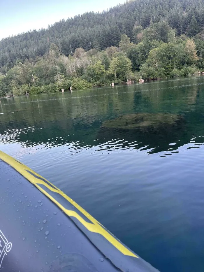 Clear water reveals sunken structure beneath surface