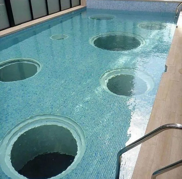 Swimming pool with unsettling deep water holes creating optical illusion