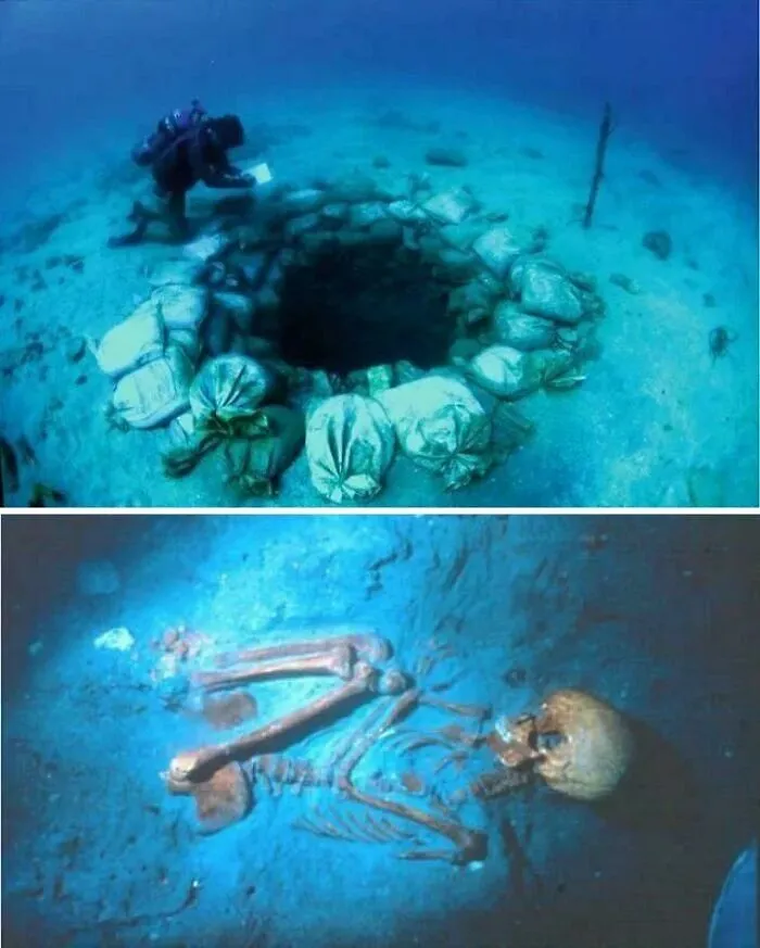 Diver exploring deep-water hole surrounded by sandbags underwater