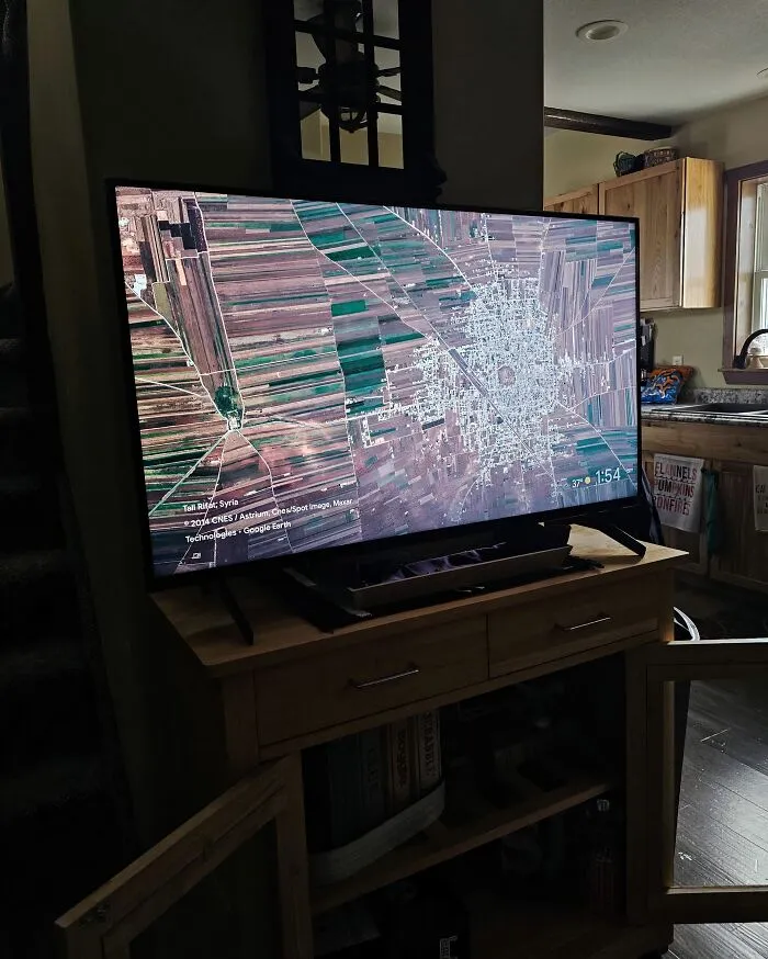 Television screen showing a satellite map view that might make your eyes play tricks on you in a living room.