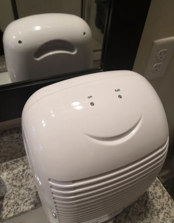 A white appliance reflection creating an optical illusion face in a mirror