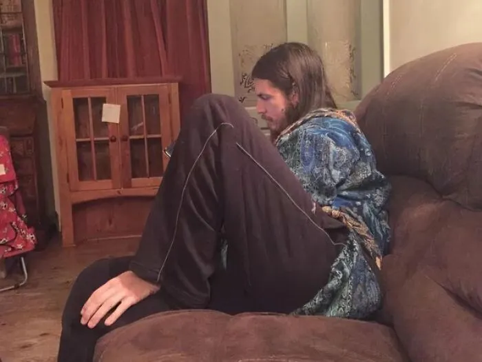 Man on sofa creating a confusing optical illusion that makes your eyes play tricks.