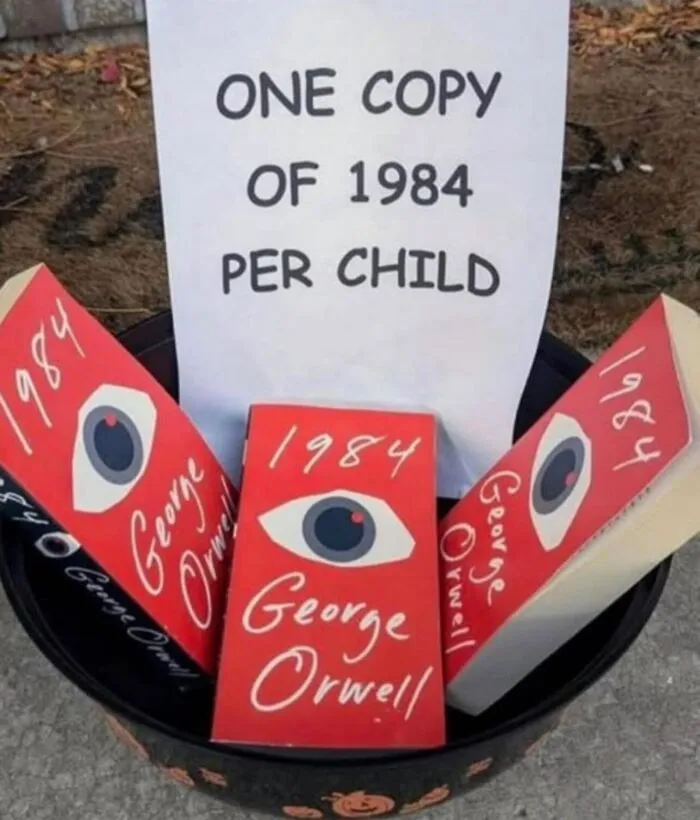 Halloween bucket filled with 1984 books instead of candy in a funny relatable meme.