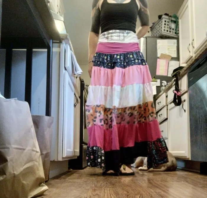 Woman wearing a handmade colorful maxi skirt showcasing creative frugal tips.