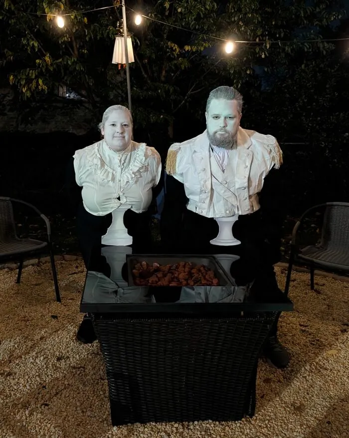 A couple dressed up as living marble busts for funny cool Halloween couples costumes