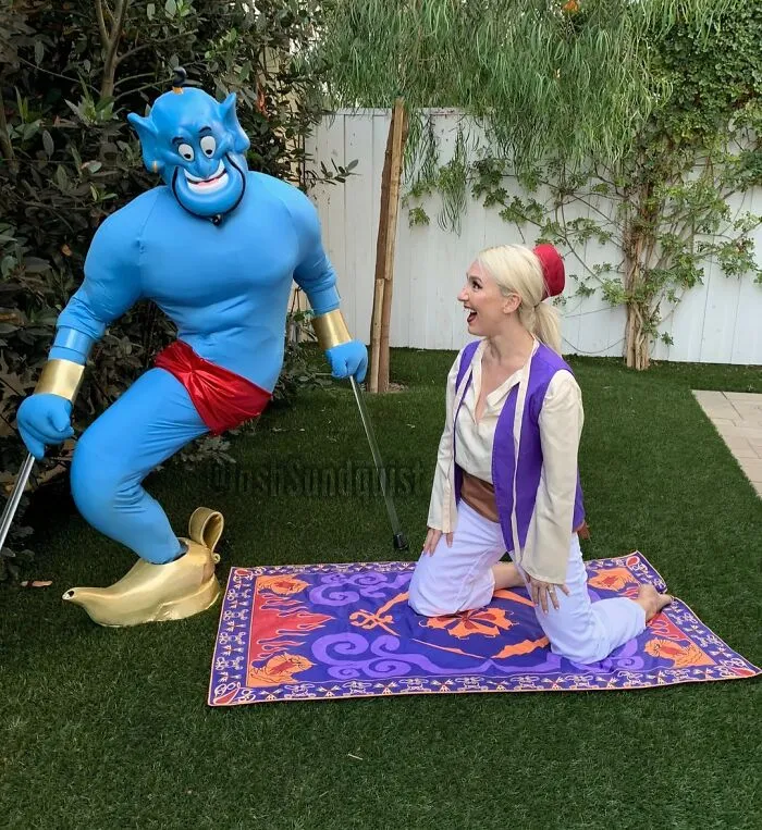Aladdin and Genie posing on a magic carpet for funny cool Halloween couples costumes