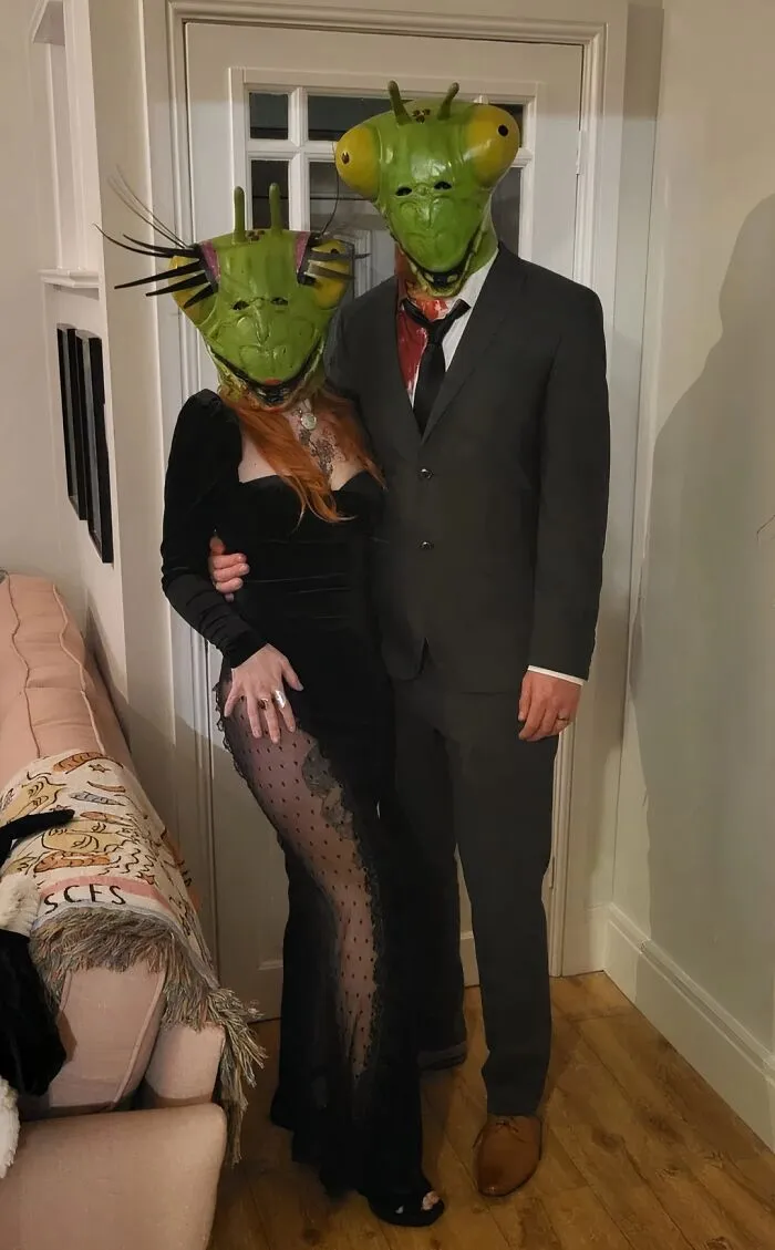 A couple wearing mantis masks and formalwear for creative funny cool Halloween couples costumes.