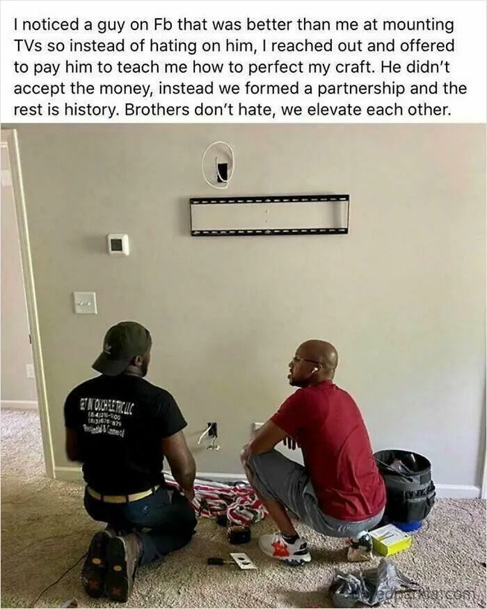 Two men installing a TV together representing wholesome moments shared on the internet.