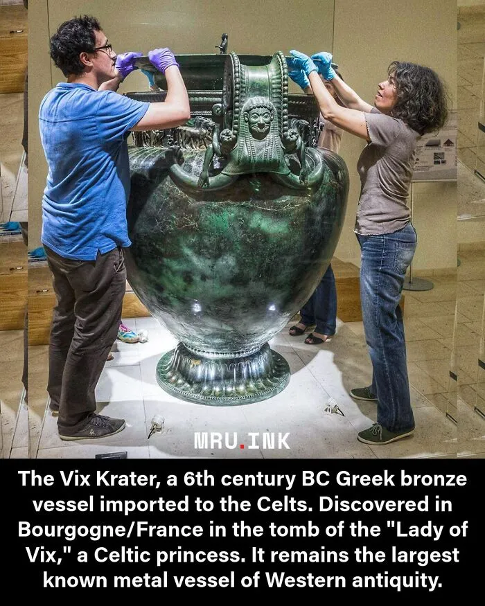 Museum conservators handle the Vix Krater bronze vessel, featured in strange photos and facts about history.
