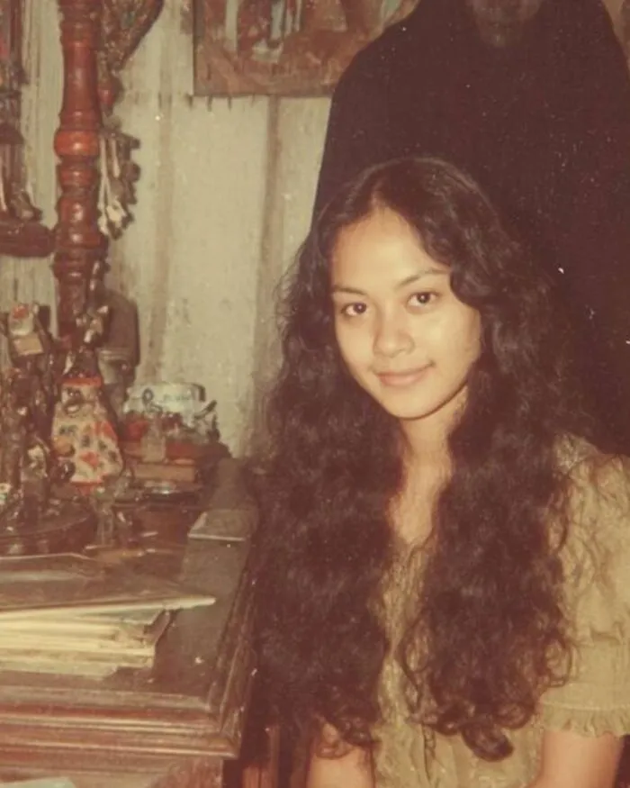 Creepy vintage real-life photo of a smiling woman with a dark shadow figure like a horror movie