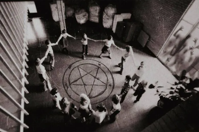 Children holding hands around a pentagram in creepy real-life photos resembling a horror movie scene