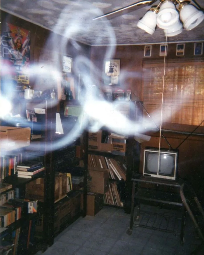 Ghostly smoke energy floating inside a cluttered room in real-life photos like a horror movie