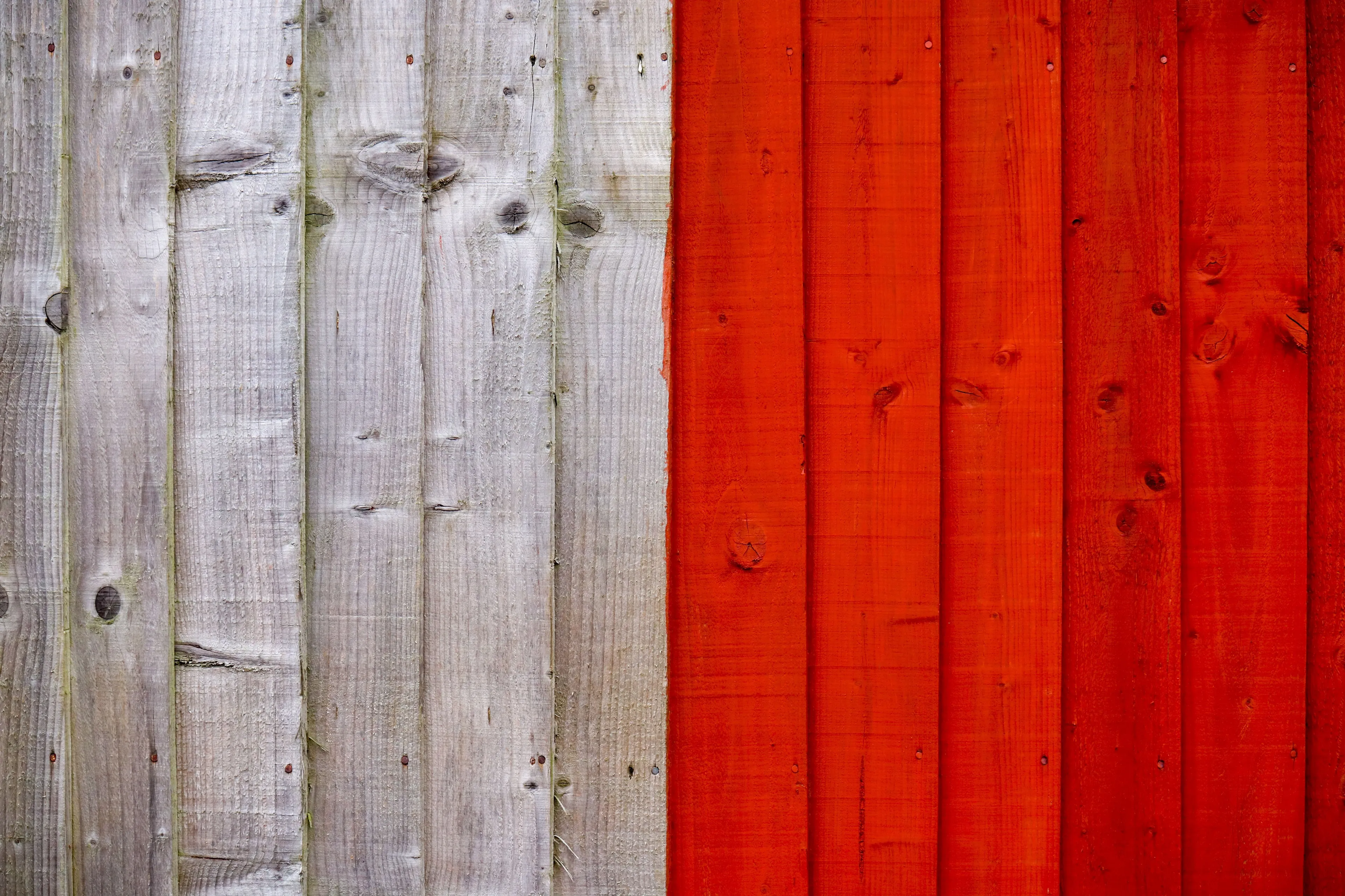 Red and white painted wooden fence panel for a general knowledge quiz question about mixing colors.