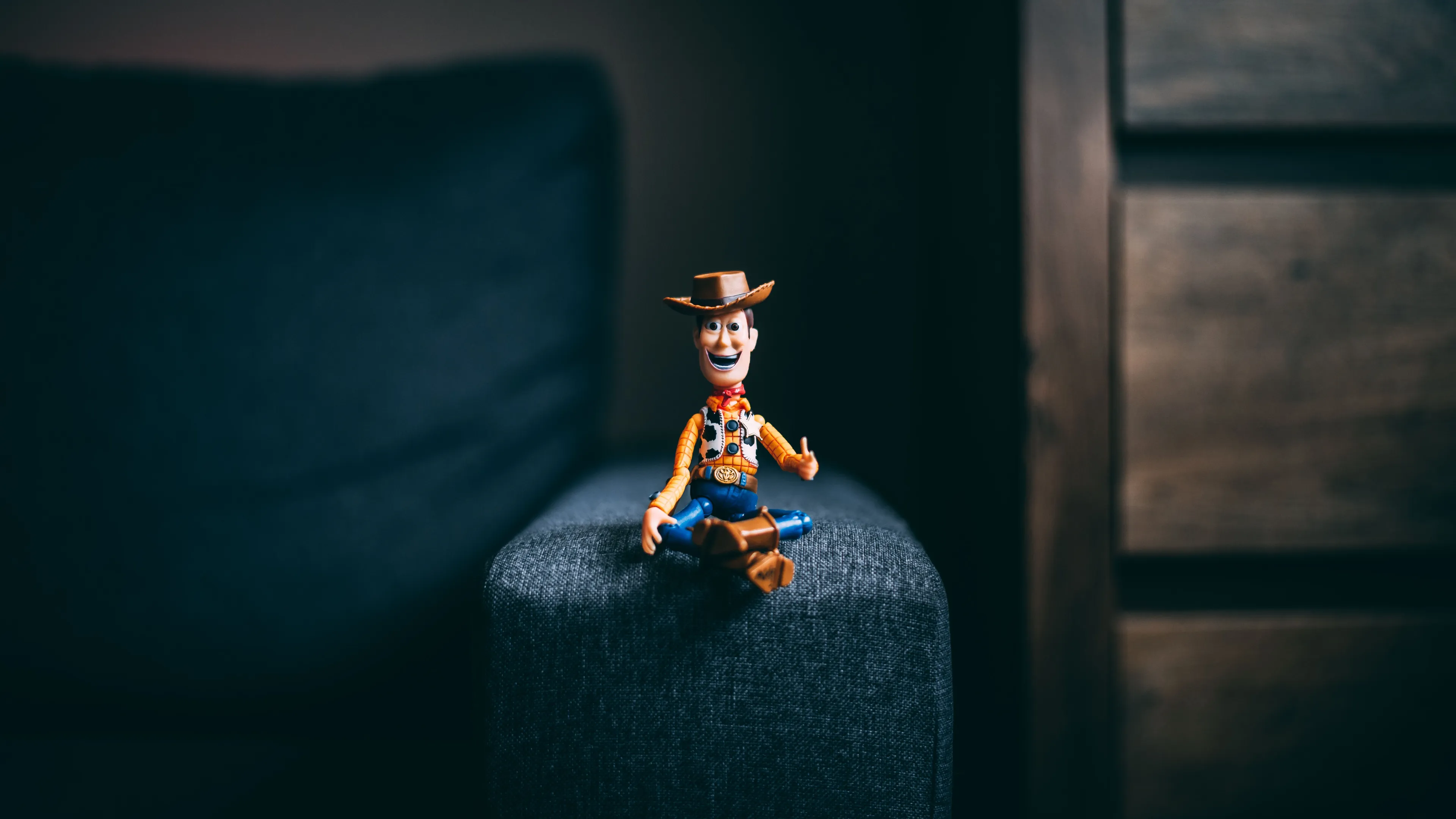 A toy cowboy figure sitting cross-legged, featured in a Toy Story trivia question.