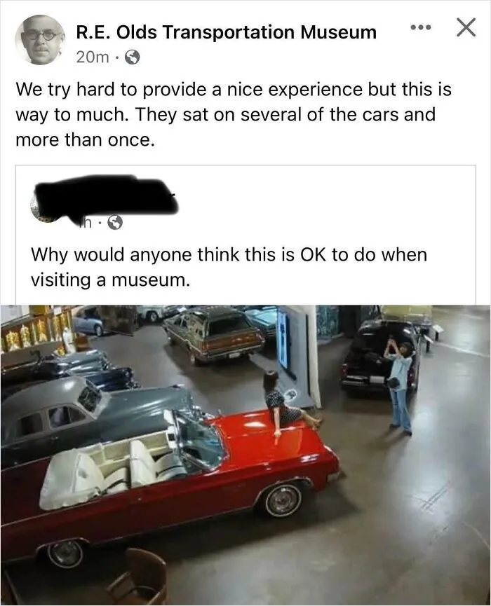 Influencers in public spaces posing sitting directly on a vintage red convertible car inside a museum