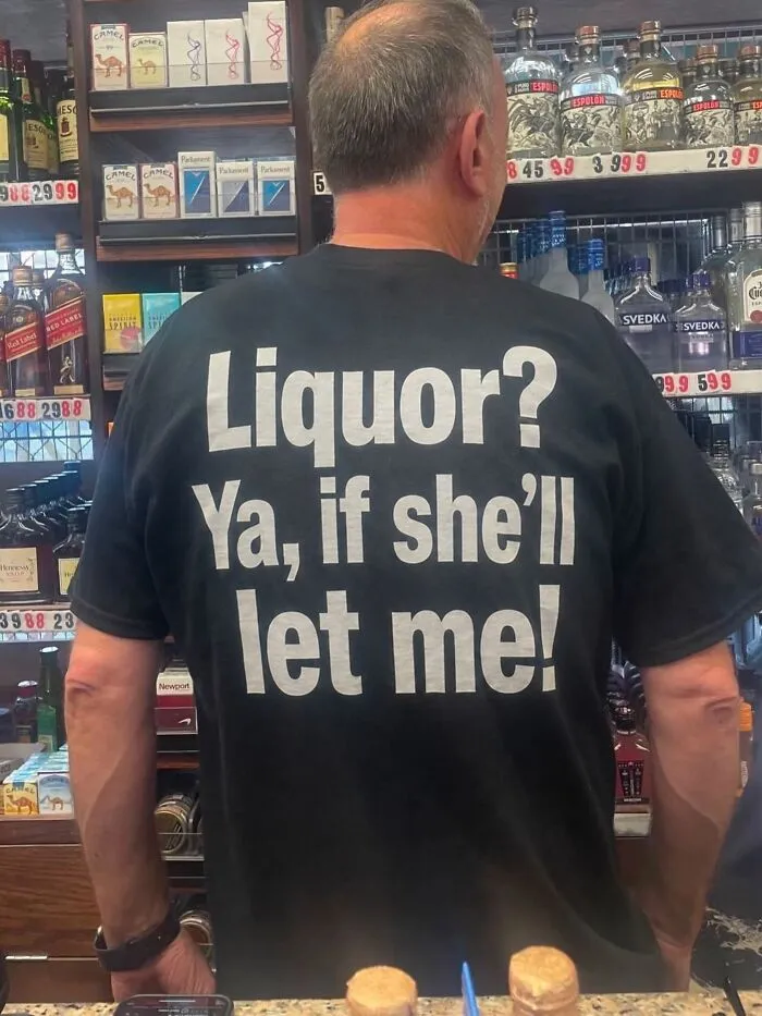 Man wearing a hilarious t-shirt with unexpected text that plays on a double entendre about liquor.