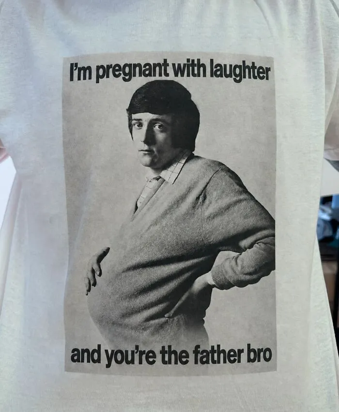 Hilarious graphic T-shirt with unexpected text about being pregnant with laughter featuring a vintage portrait