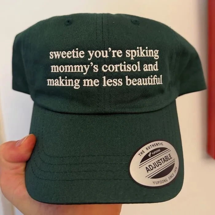 Dark green baseball cap with hilarious text about spiking cortisol.