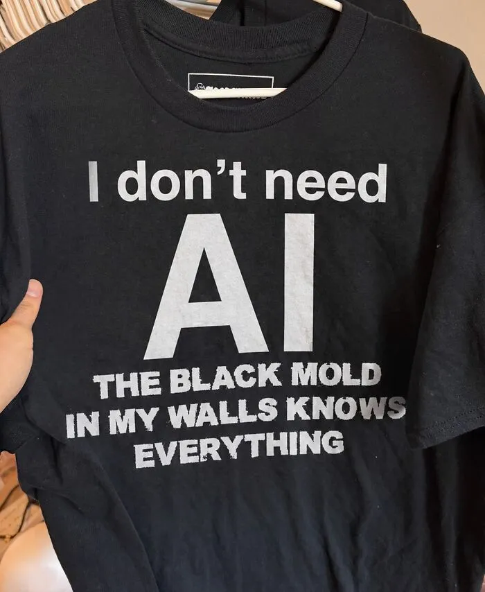 Black t-shirt featuring funny text about AI and black mold in walls.