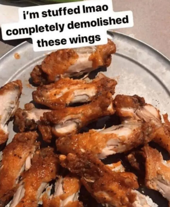 Absurd internet post image of barely eaten chicken wings with a humorous caption.