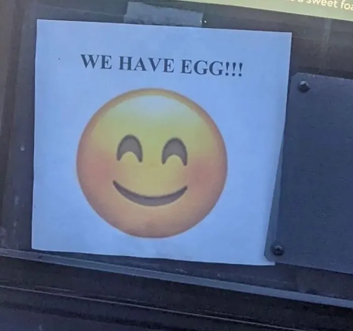Absurd internet post showing a sign saying WE HAVE EGG with a smiling emoji