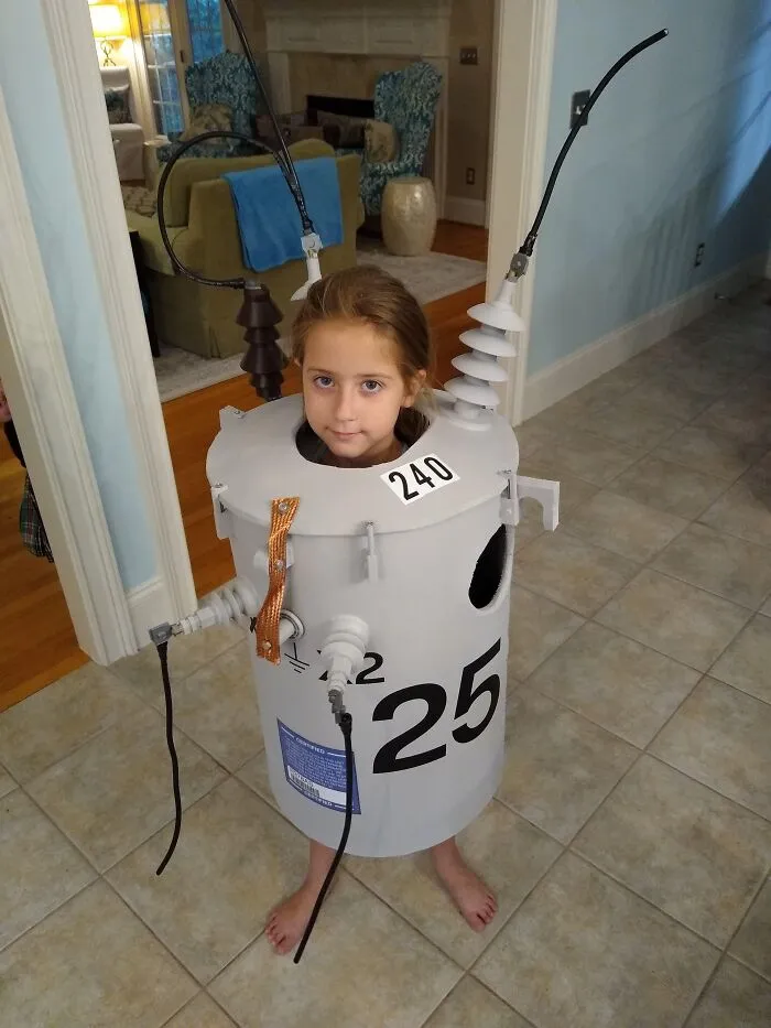 Funny Halloween costume of a young girl dressed as an electrical transformer.