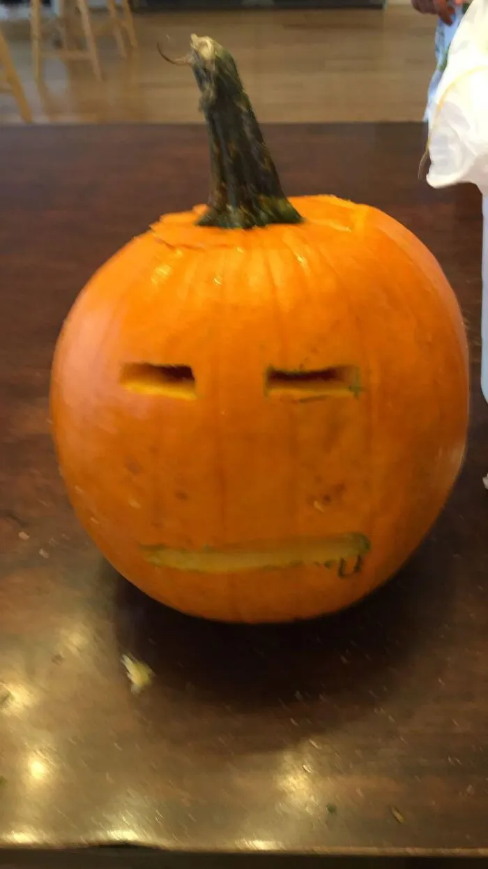 Carved pumpkin with simple straight slit eyes and mouth when Halloween didn't go as planned.