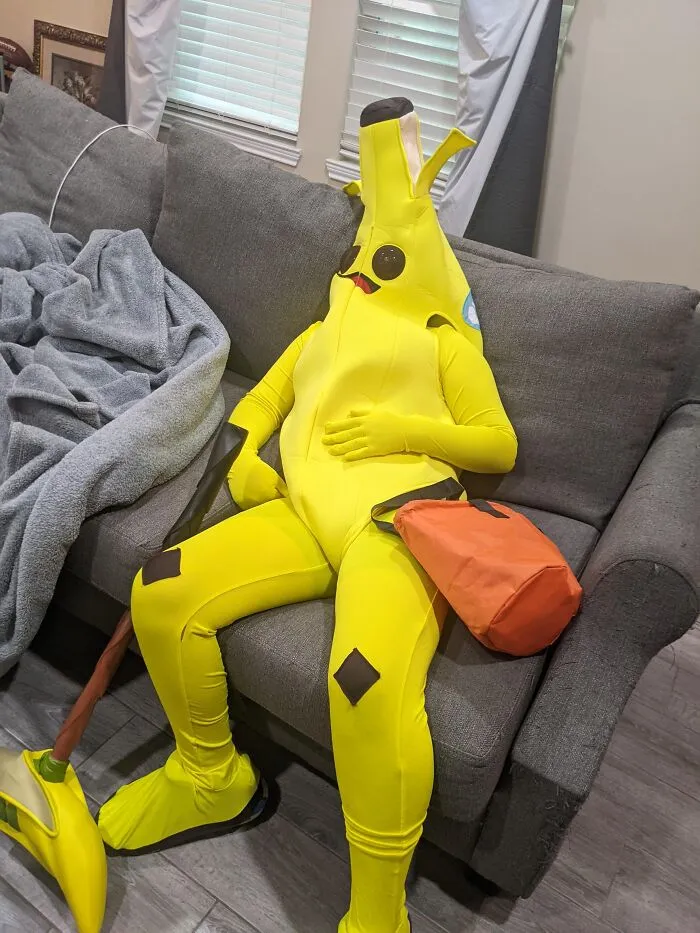 Person slumping on a sofa in a banana costume when Halloween didn't go as planned.