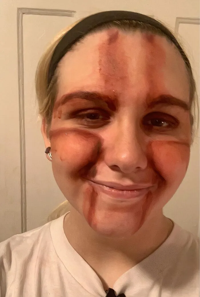 Smudged face paint failure on a woman, showing when Halloween didn't go as planned