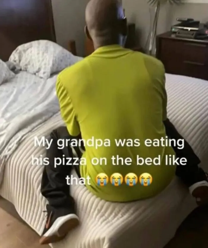 Absurd internet posts image of a person sitting awkwardly on a bed eating pizza.