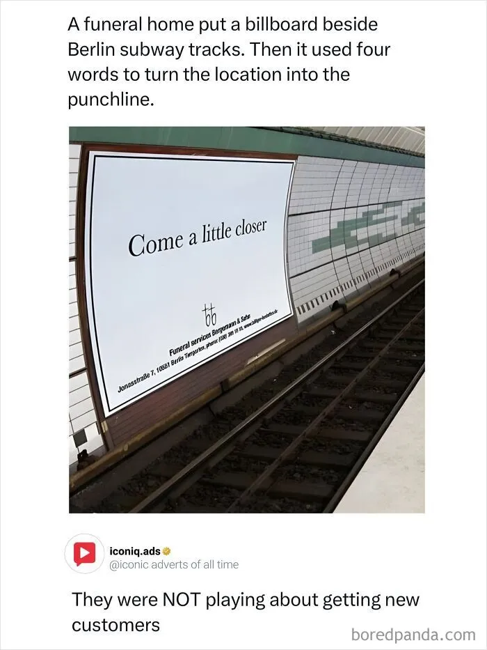 A white billboard on a subway track reading Come a little closer as an example of entertaining ads.
