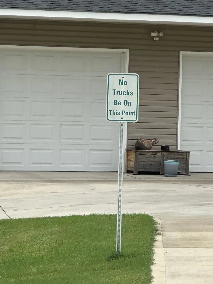 A sign outside reading No Trucks Be On This Point showing a spelling fail