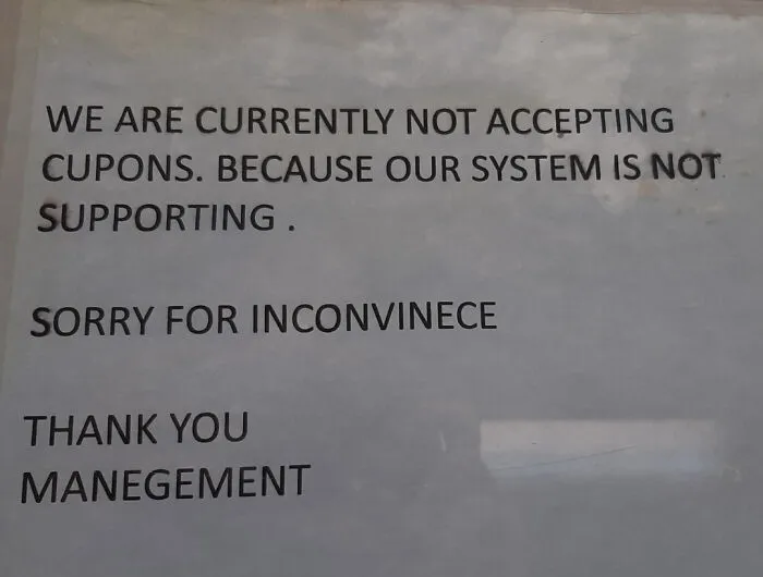 Notice with spelling fails including cupons and manegement on a window