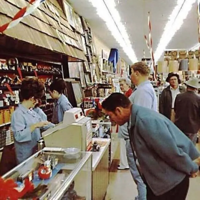 Shoppers and cashiers inside a vintage department store featured in old photos of America.