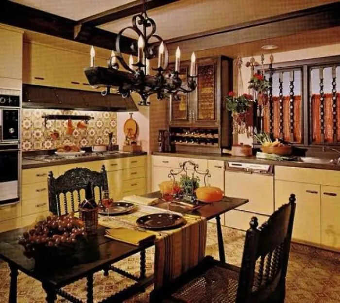Charming retro 1970s kitchen featuring warm wooden cabinets, tile backsplashes, and a set dining table
