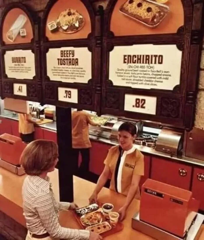 Vintage photo showing a Taco Bell counter with menu options like Enchirito in classic America.