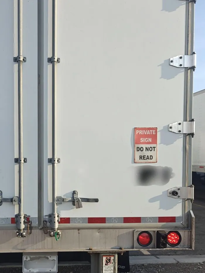Creative truckers joke with a sign reading private sign do not read on the back of a white truck.