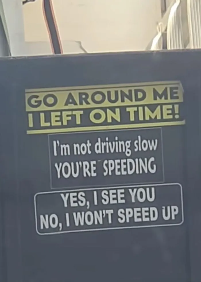 Close up of funny bumper stickers on a vehicle expressing humorous driving attitudes and messages