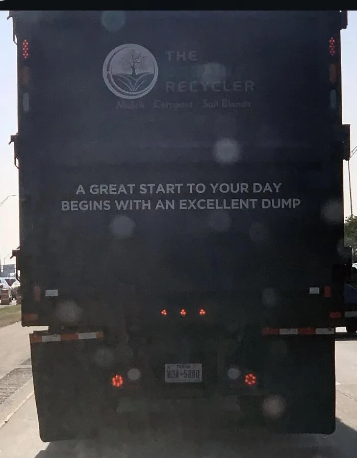 Back of a dump truck with the humorous slogan A great start to your day begins with an excellent dump