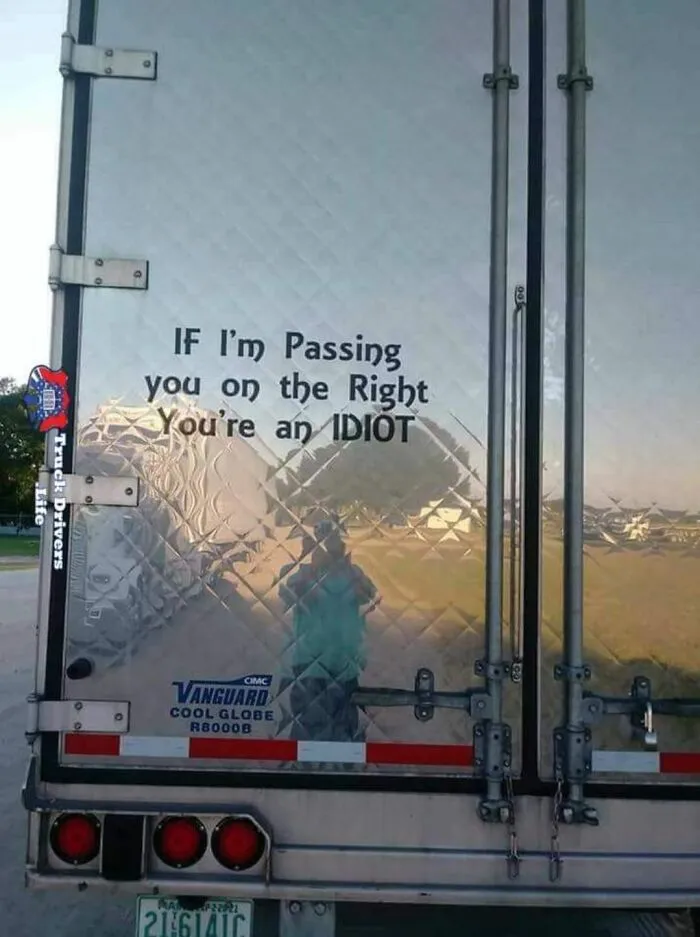 Rear door of a semi-truck displaying a witty sign by truckers who turned their vehicles into jokes
