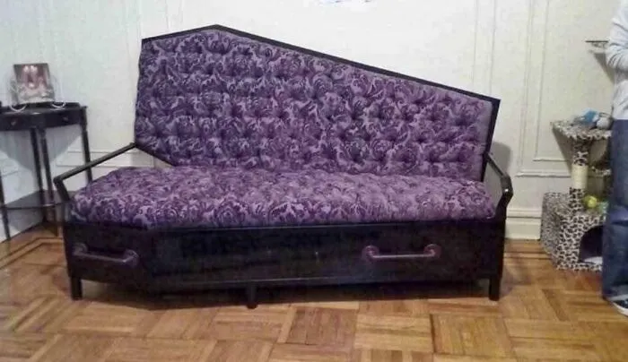 A coffin sofa with purple velvet upholstery, a unique creation far too well-made to ignore.