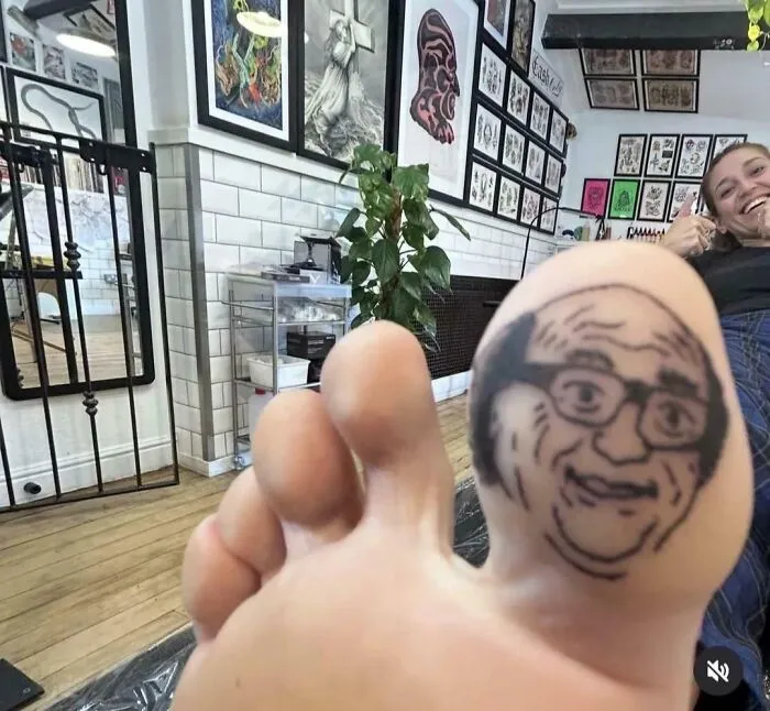 A tattoo of a man's face on a big toe, showing awful creations made with impressive detail.