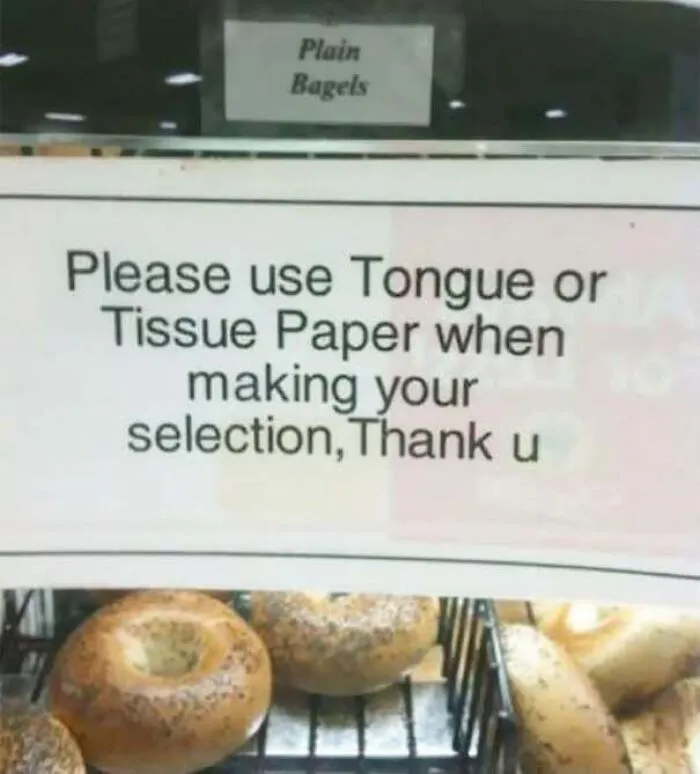 A store sign with a funny typo instructing customers to use tongue instead of tongs, showing someone confidently wrong.