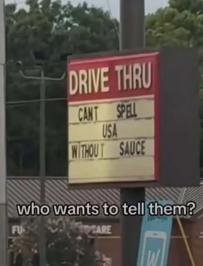 A drive-thru sign with a typo reading Cant spell USA without sauce, an example of being confidently wrong.