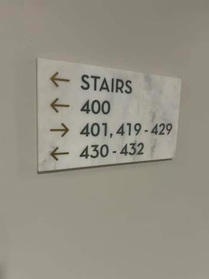 A confusing wall sign with contradictory directions illustrating people being confidently wrong.