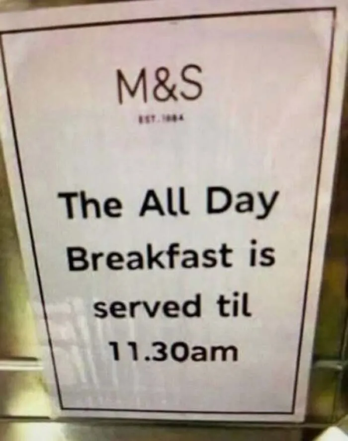 An M&S sign stating All Day Breakfast served til 11:30am, showing someone confidently wrong about all day.