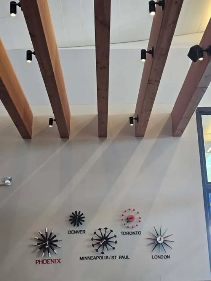 Wall clocks showing different city times mounted incorrectly, showing people confidently wrong in real life.