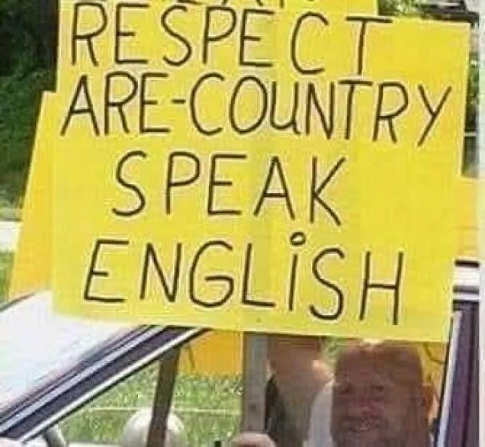 Protest sign with spelling errors demanding English, an example of someone being confidently wrong
